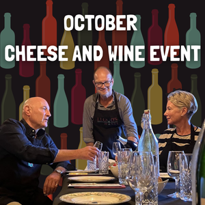 PEOLPE SEATED AT A TABLE WITH SIMON POURING WINE