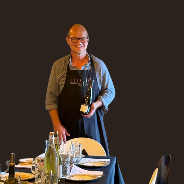 SIMON LLOYD OF LOYDS WINES PRESENTING A BOTTLE OF THREE PEAKS WINE
